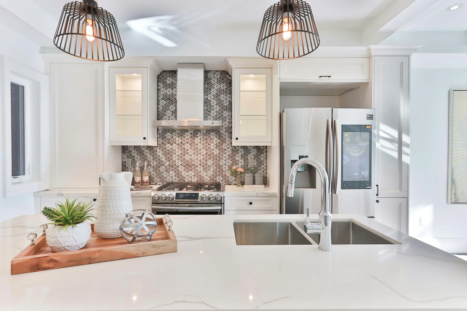 A sparkling clean, modern kitchen with white cabinets and a double sink